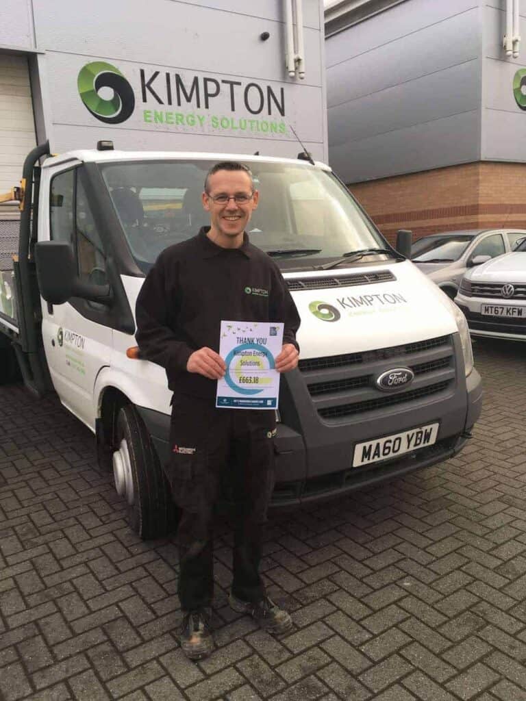 Lee Williams the Kimpton Stores Manager with his certificate after raising money for Clatterbridge